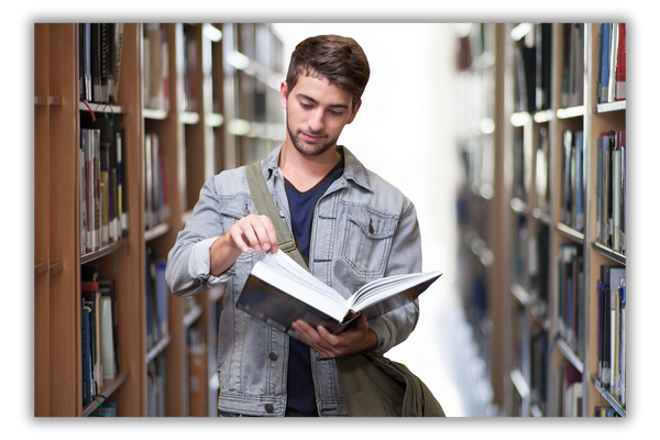 male student flipping through book