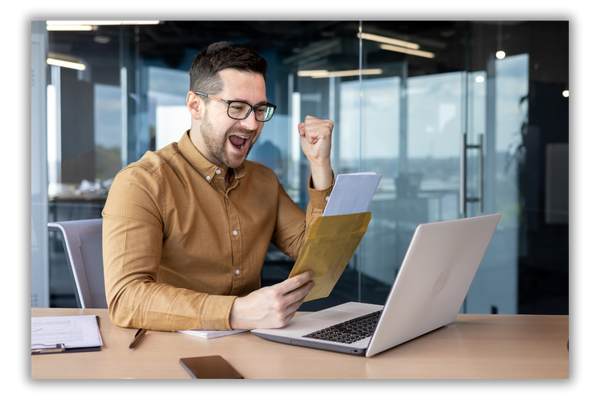 excited applicant opening letter in front of computer