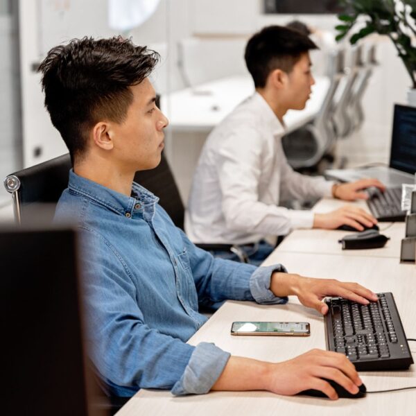 Two people looking at computers