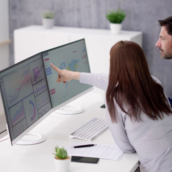 People looking at data on a computer monitor