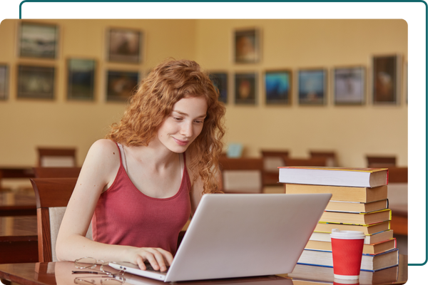 A woman happily using a laptop