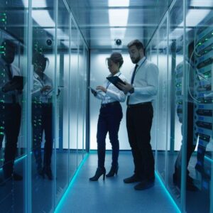 Two people looking at computer stacks